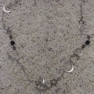 A silver and black beaded necklace w/ earrings